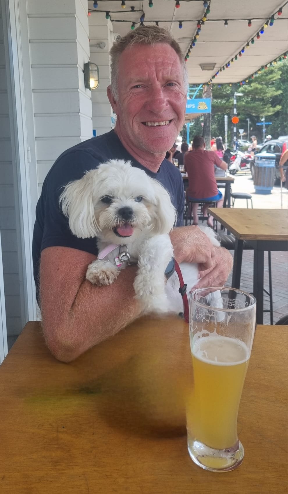Carl relaxing with a dog during a pet sitting stay